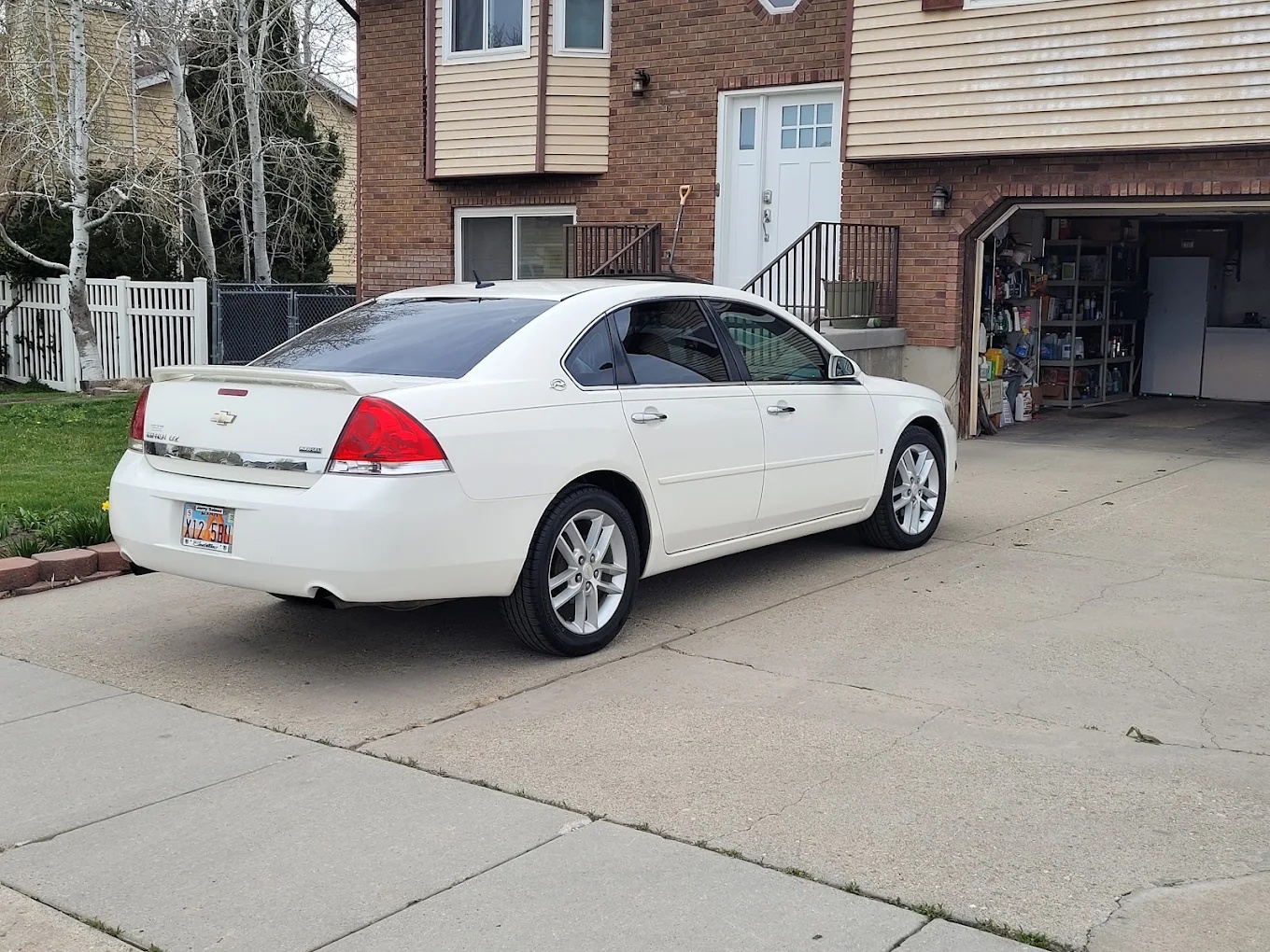 White Chevrolet Impala washed and polished in a residential driveway